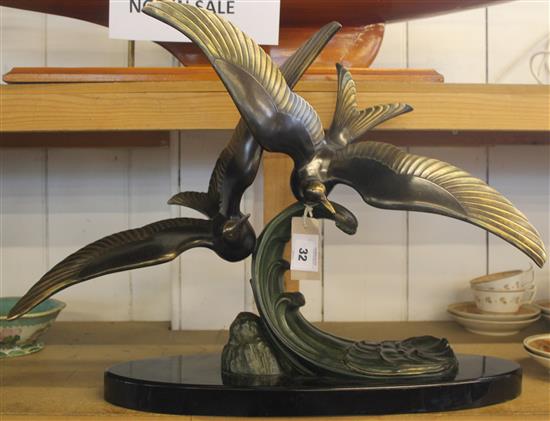 Trebig. An Art Deco patinated bronze group of two seagulls flying over a wave, 16.5in.(-)